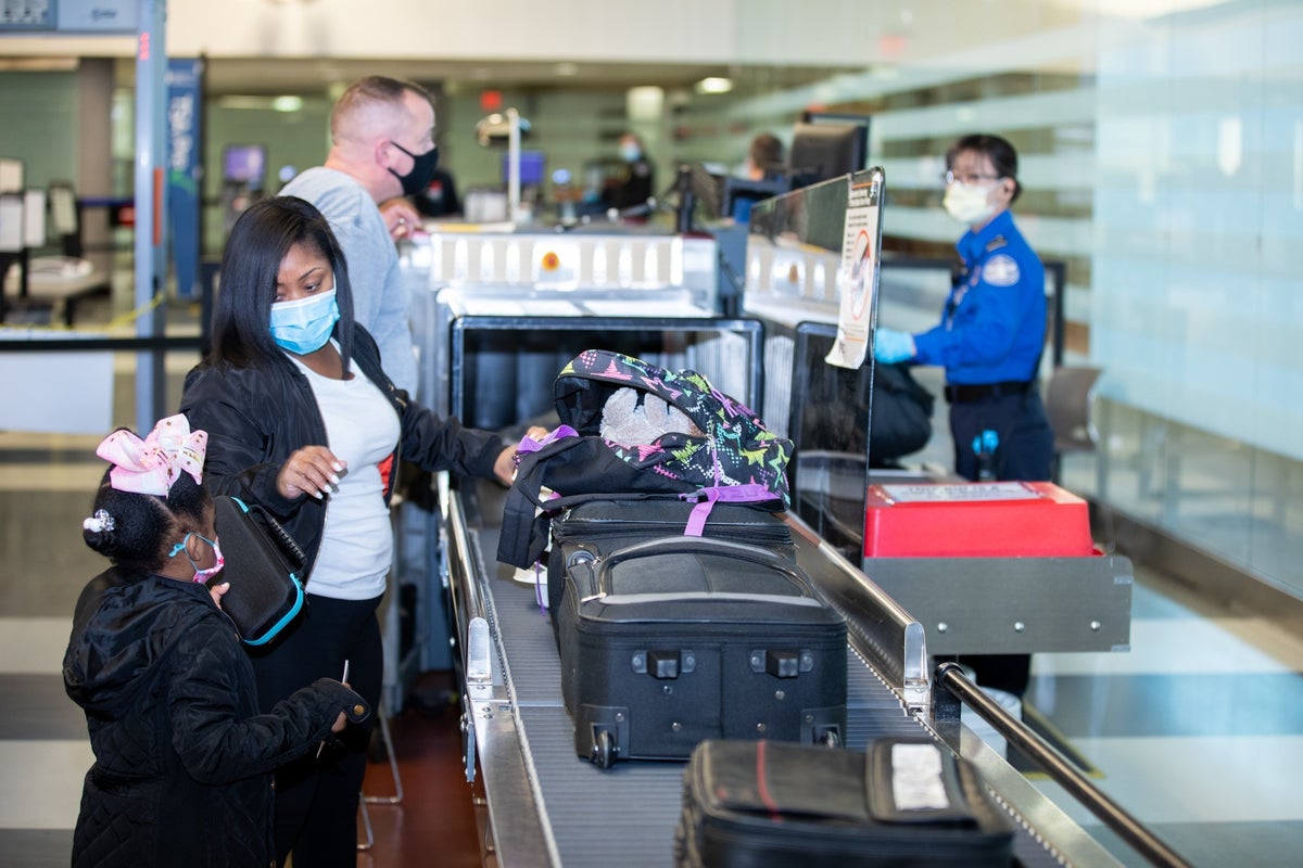 A mother and daughter going through airport security.